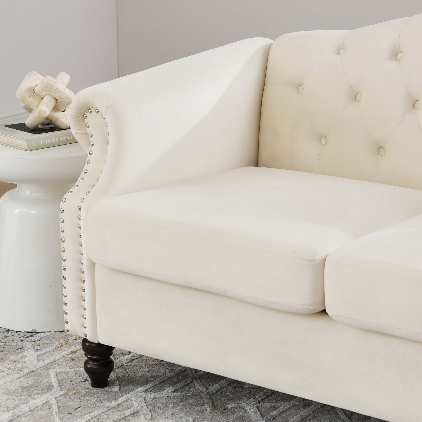 Cream velvet chesterfield sofa with tufted back and silver nailhead trim