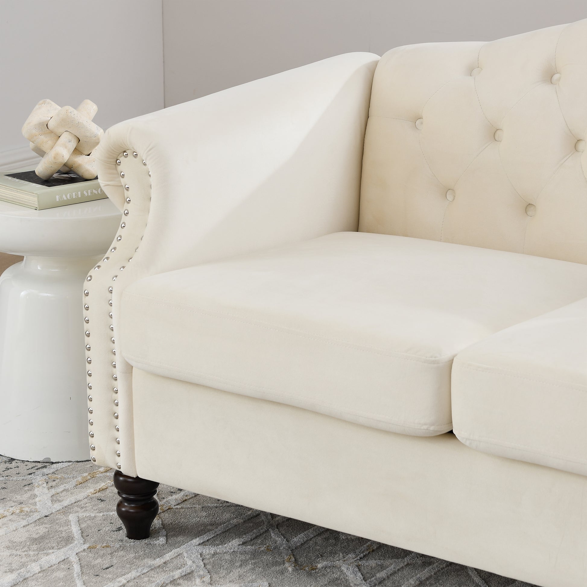 Cream velvet chesterfield sofa with tufted back and silver nailhead trim