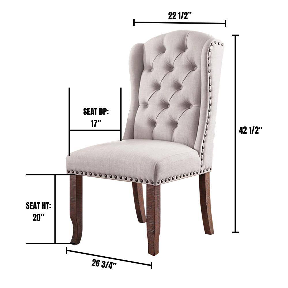 Tufted beige wingback dining chair with nailhead trim and dark wood legs