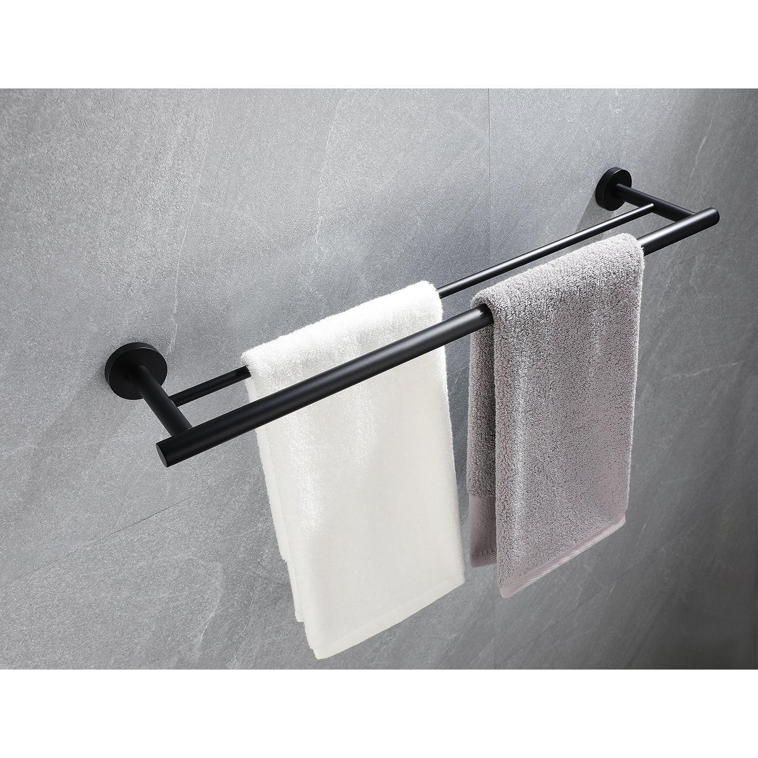 Black double towel bar with white and grey bath towels mounted on a gray tiled wall
