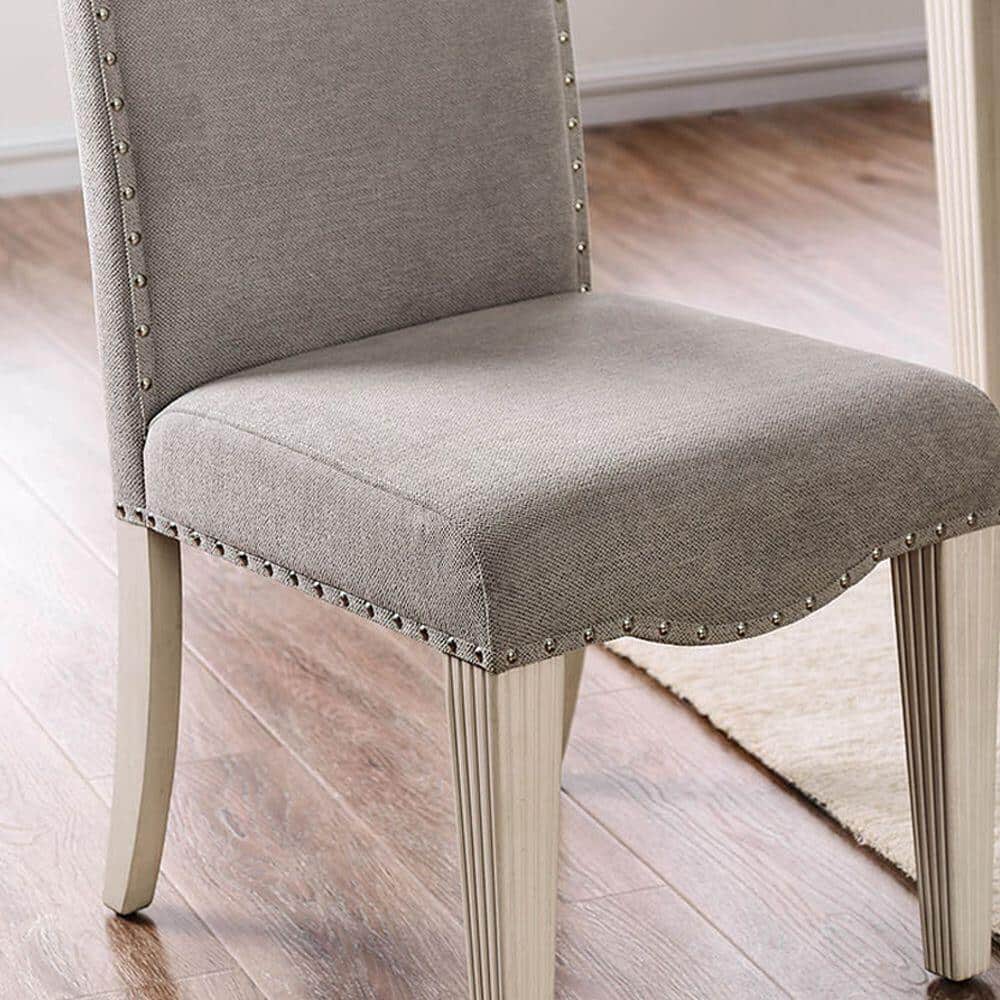 Upholstered dining chair with nailhead trim and light wood legs