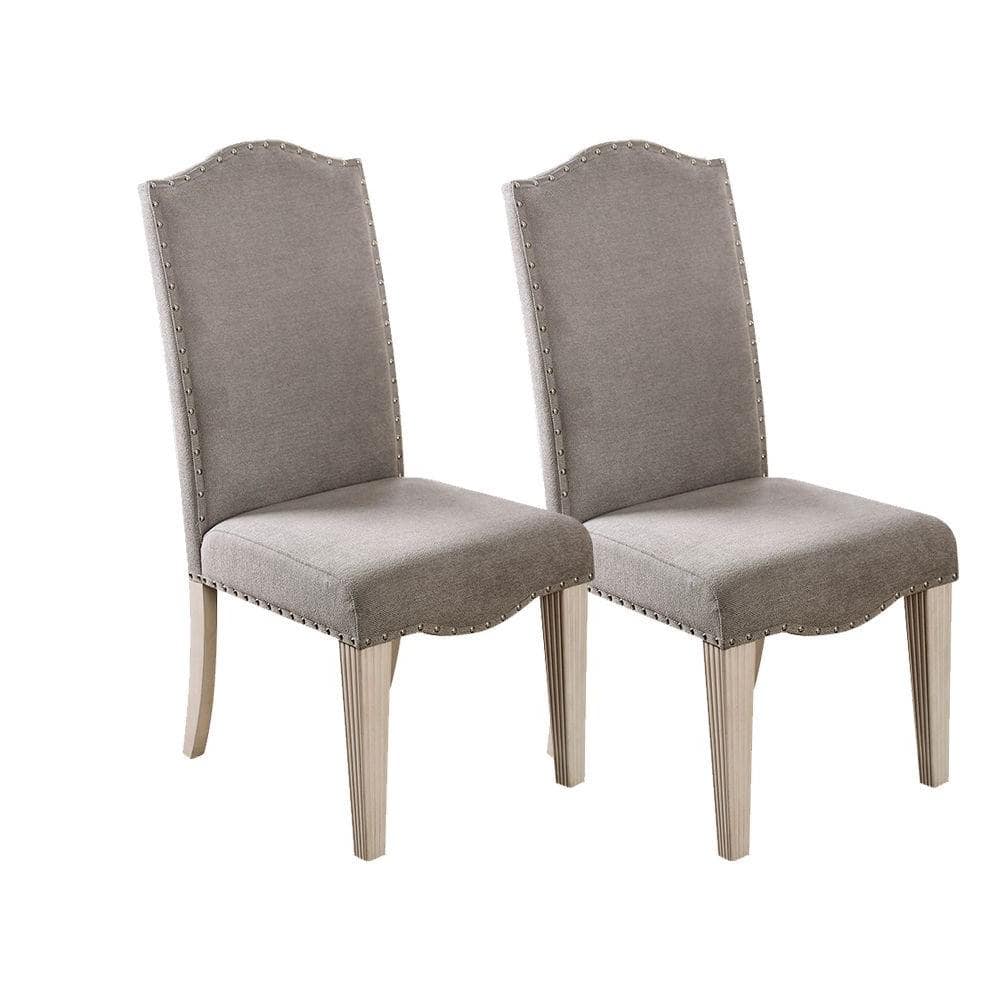 Gray upholstered dining chairs with nailhead trim and light wood legs