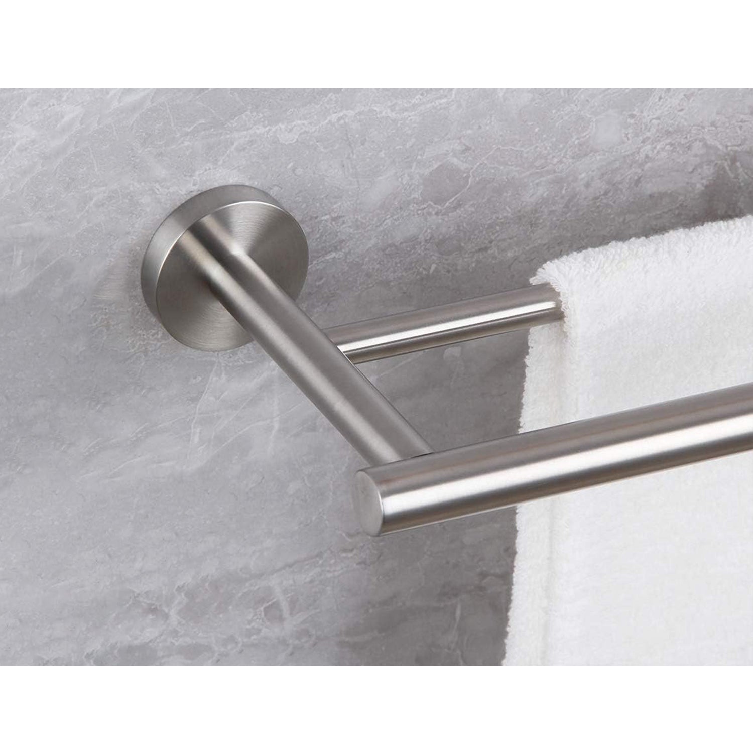 Brushed nickel double towel bar with modern design mounted on marble wall