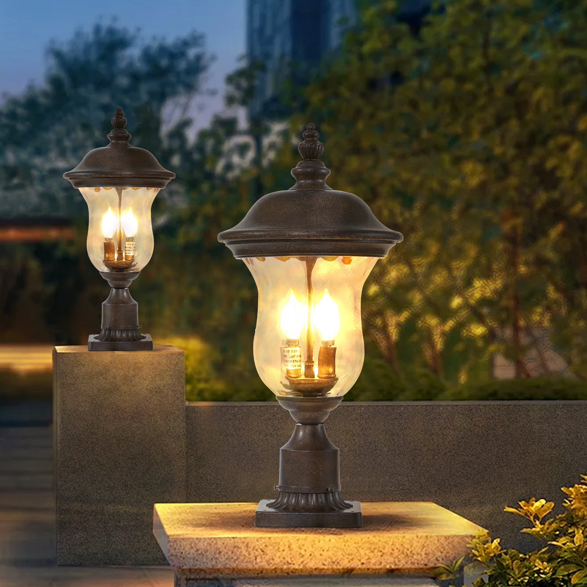 Ornate bronze post lantern with clear glass globe and two flamestyle bulbs