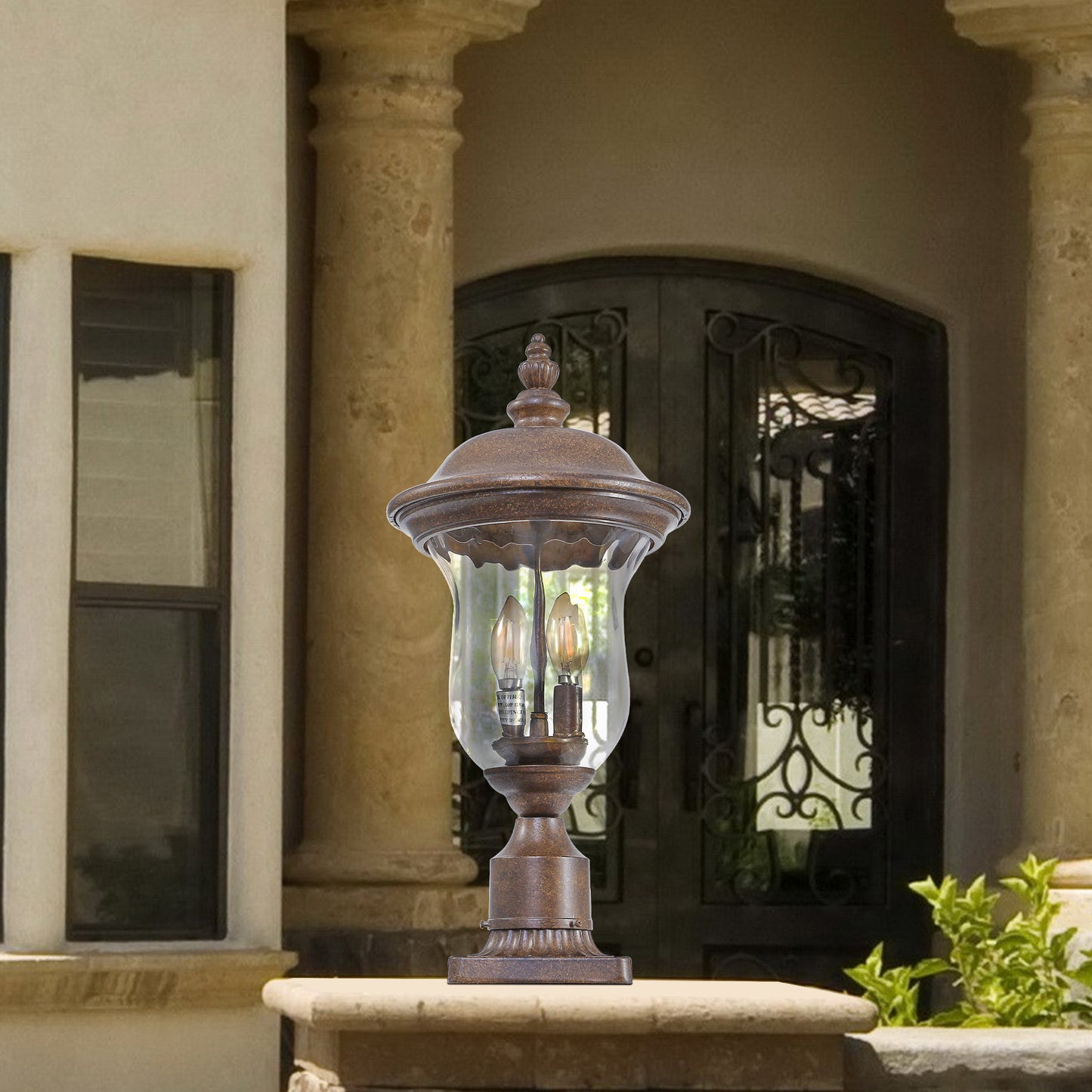 Traditional bronze outdoor post light with clear seeded glass and two visible bulbs