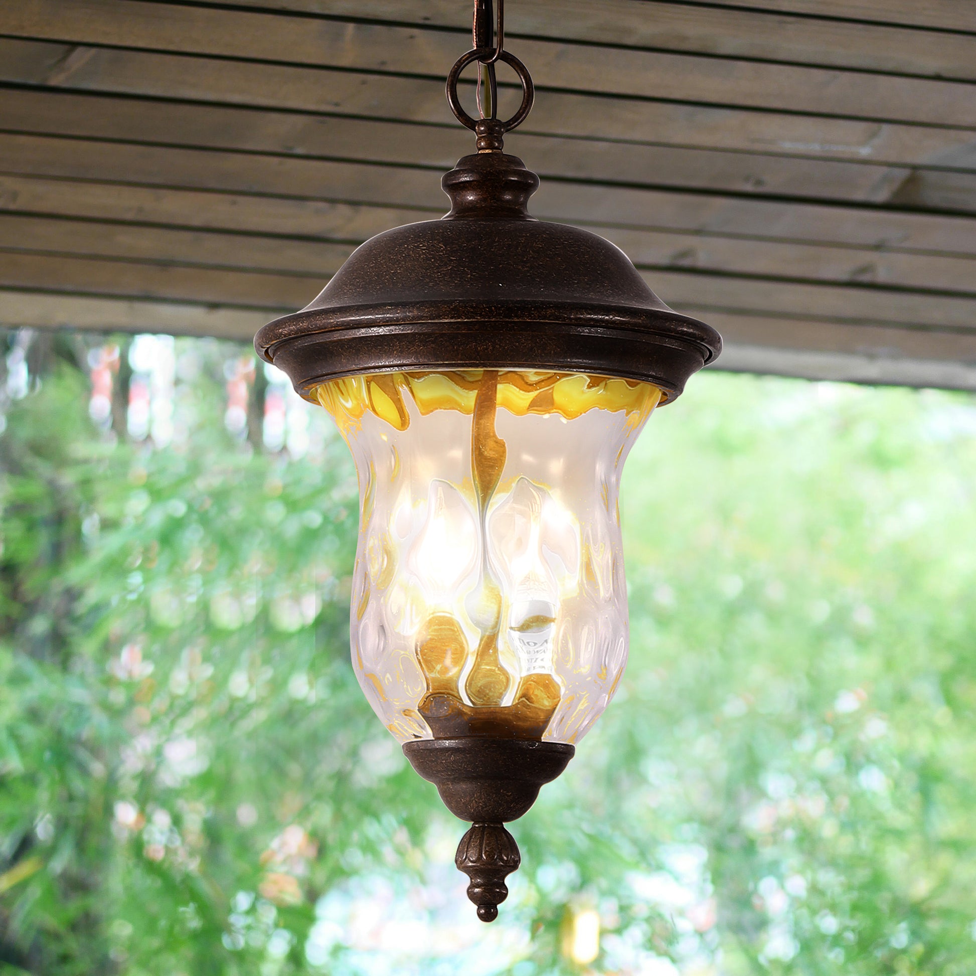 Rustic bronze outdoor lantern with clear seeded glass and amber accents