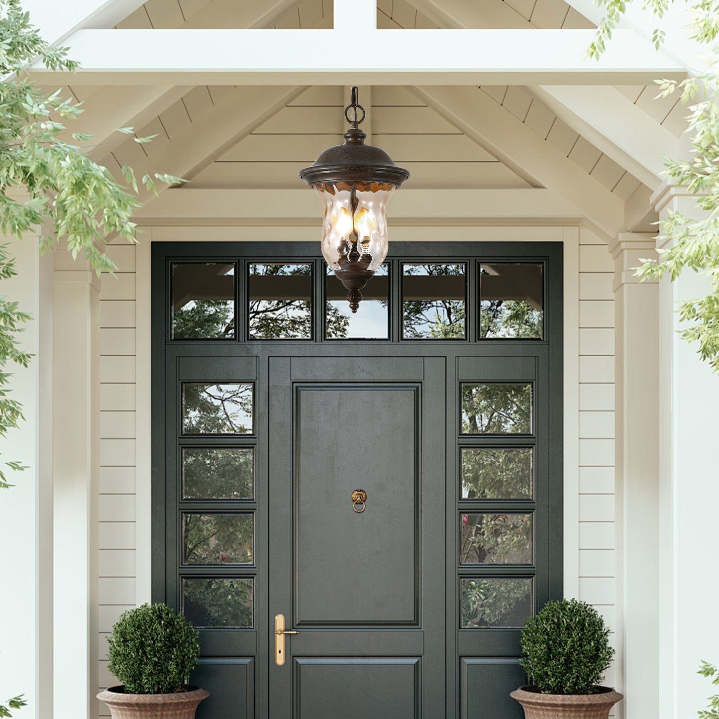 Ornate bronze outdoor hanging lantern with seeded glass adds elegance to home entrance