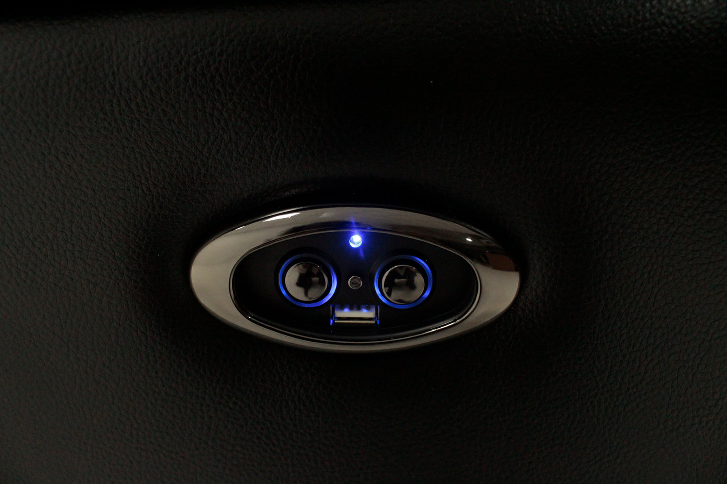 Black leather sofa with illuminated USB charging ports and control buttons