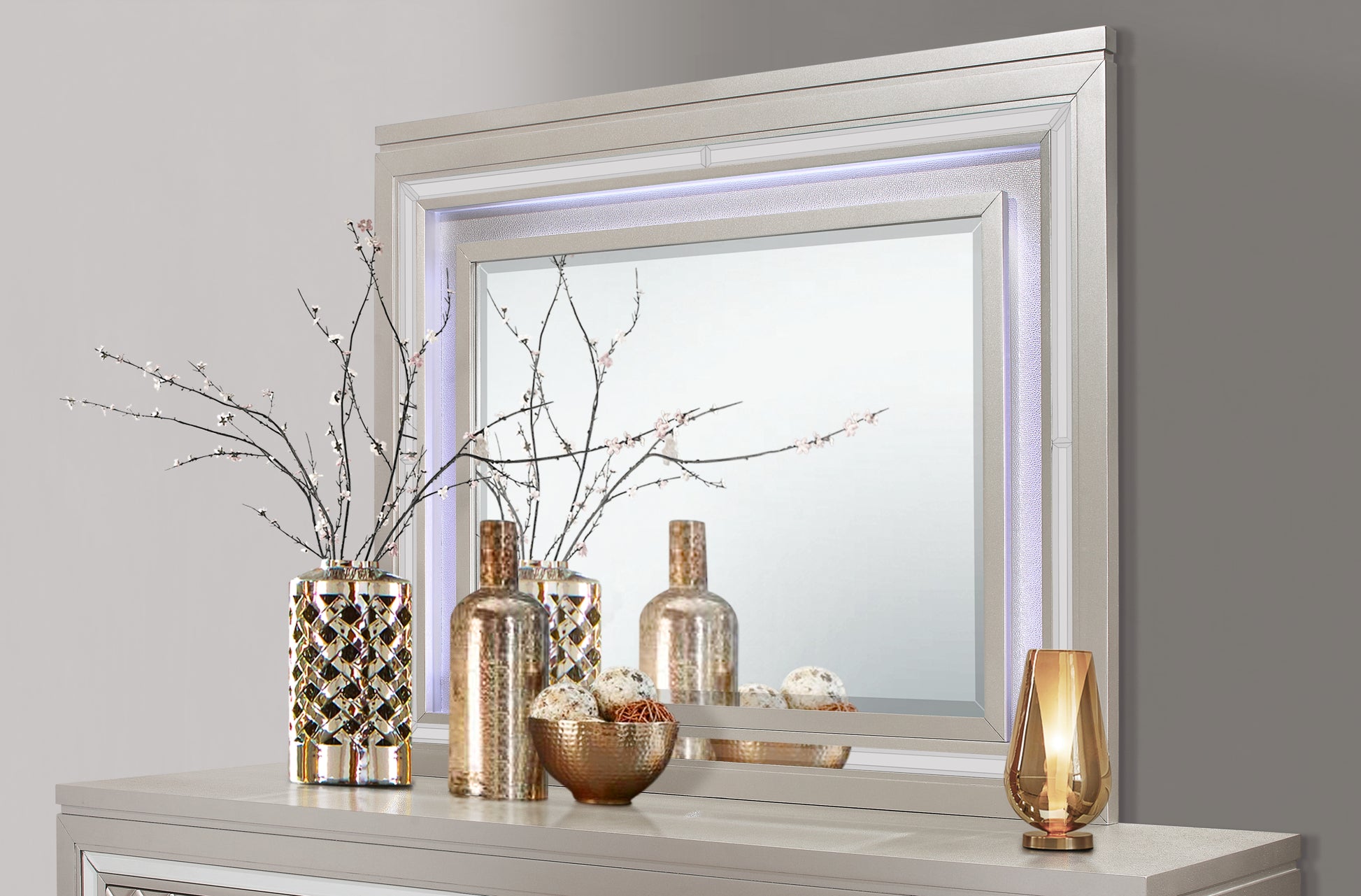 Glamorous mirrored dresser top with decorative vase and ambient lighting