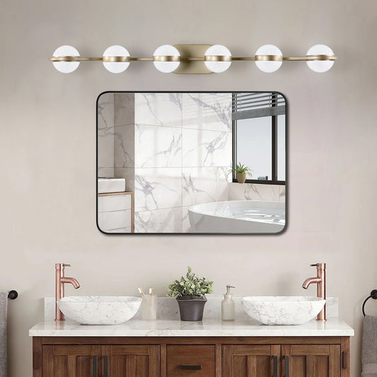 Modern brass vanity light with frosted glass globes for bathroom lighting