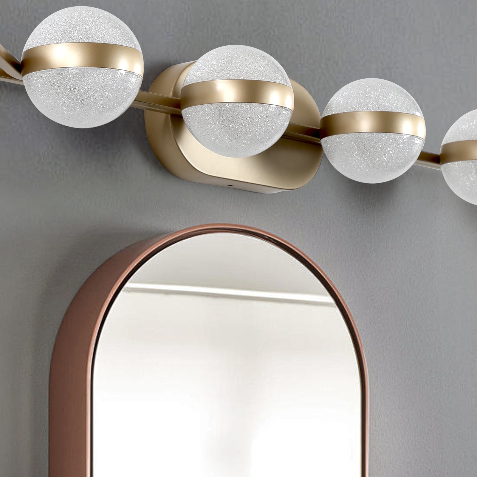 Modern gold vanity light with frosted glass globes and brushed brass accents