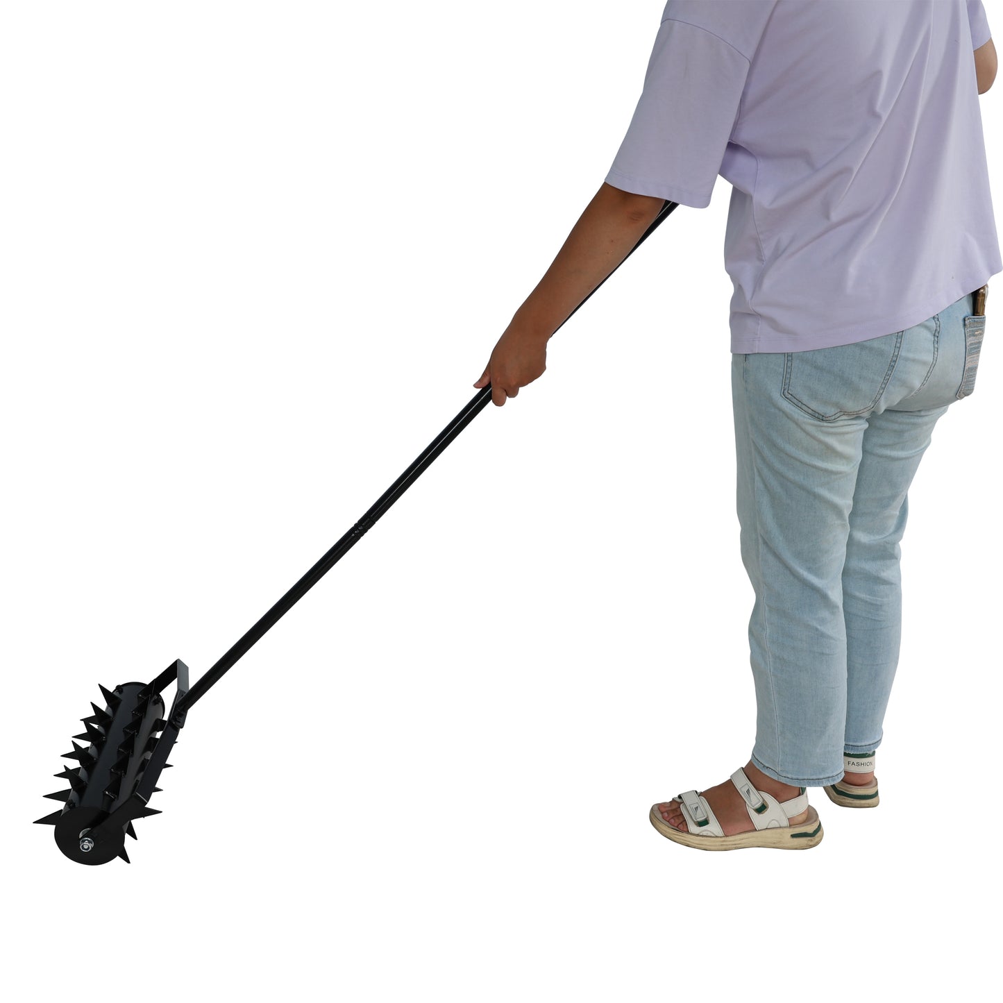 Black spiked lawn aerator tool with long handle for garden maintenance