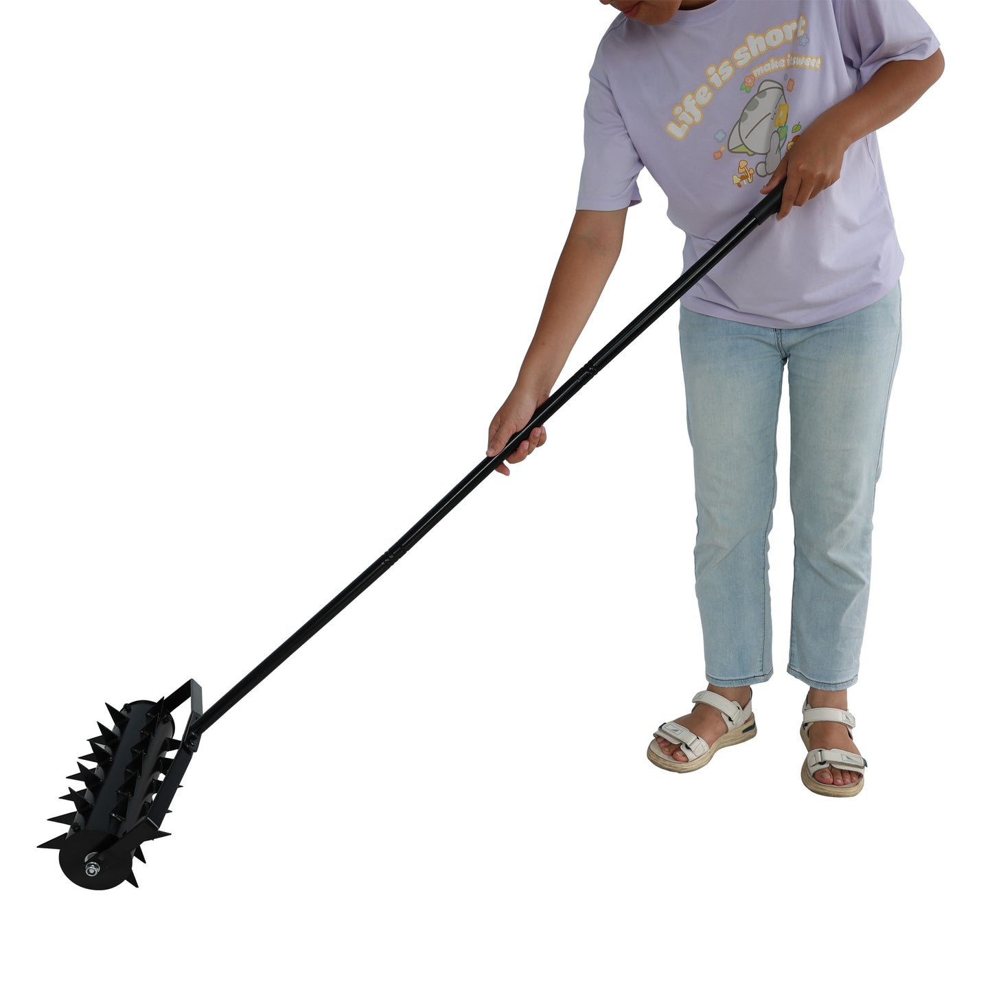 Black metal lawn aerator with long handle ideal for garden maintenance