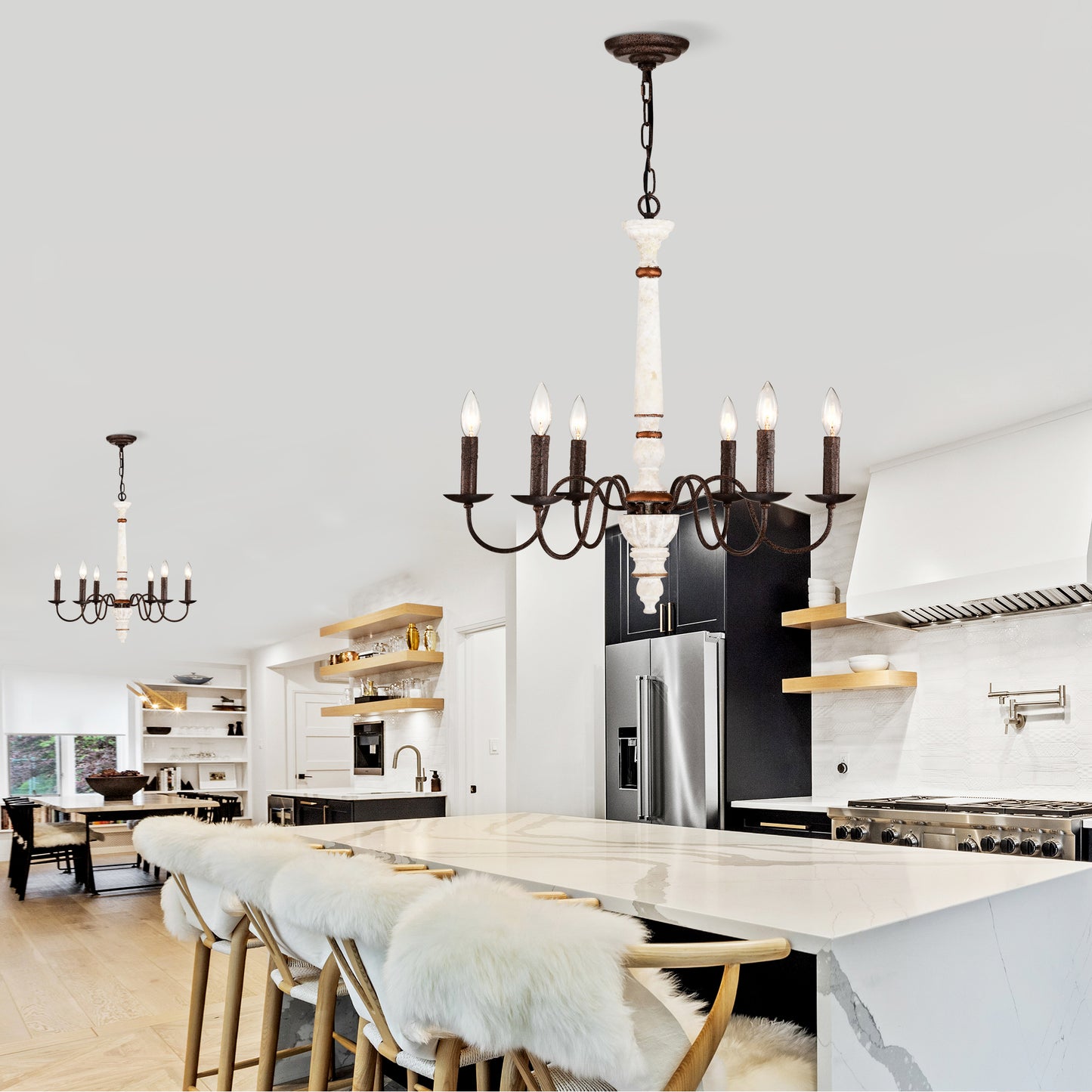 Rustic bronze chandelier with marble accents illuminates a modern kitchen island