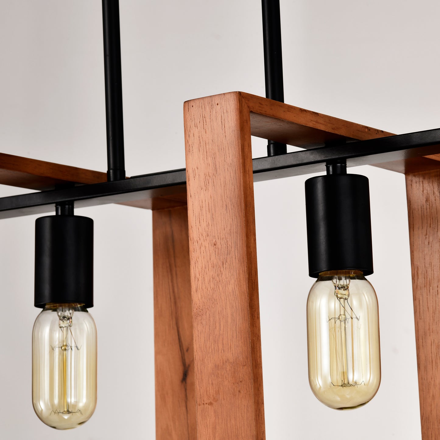 Modern industrial pendant light with wooden frame and black accents featuring Edison bulbs