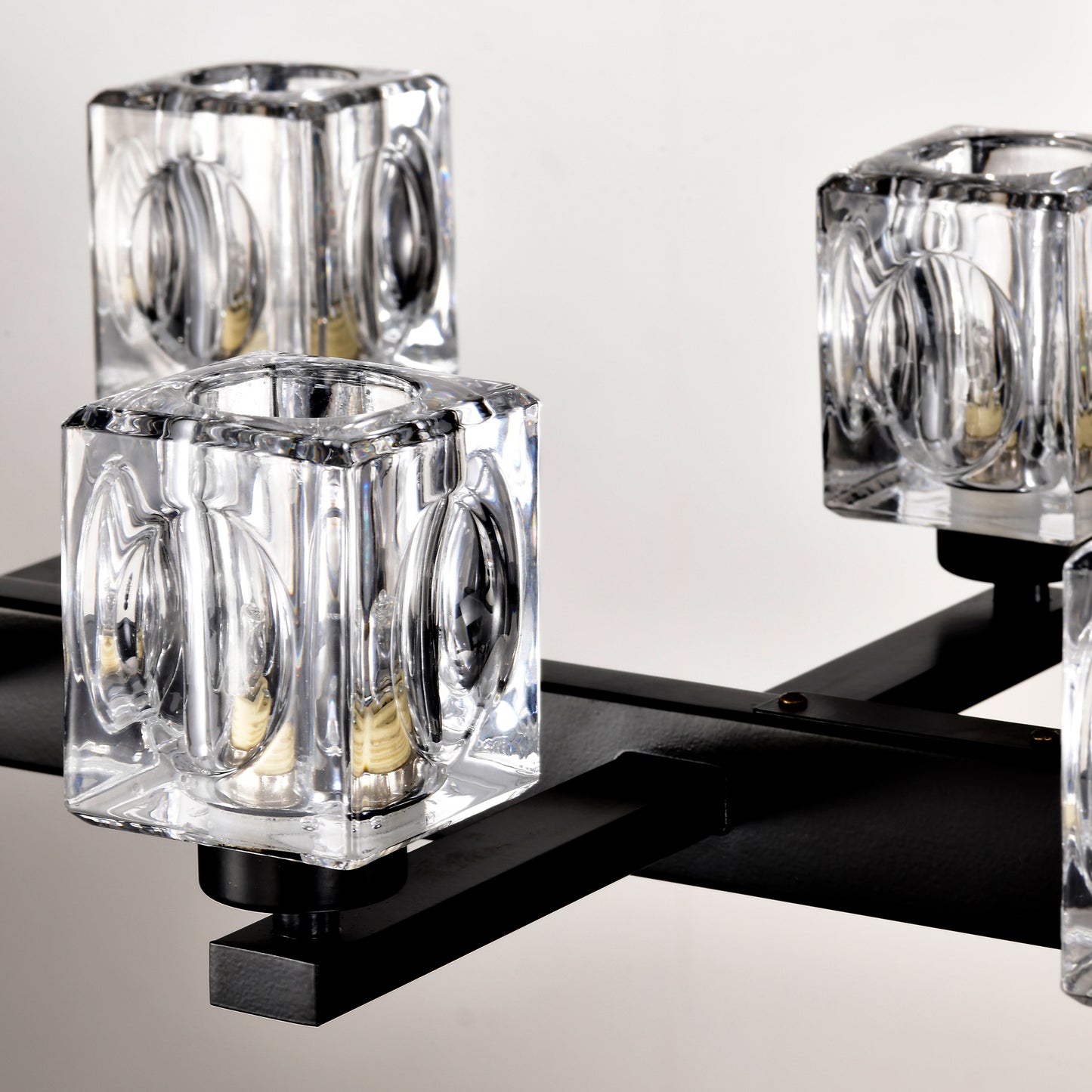 Clear cubic crystal sconce with black metal accents for modern lighting