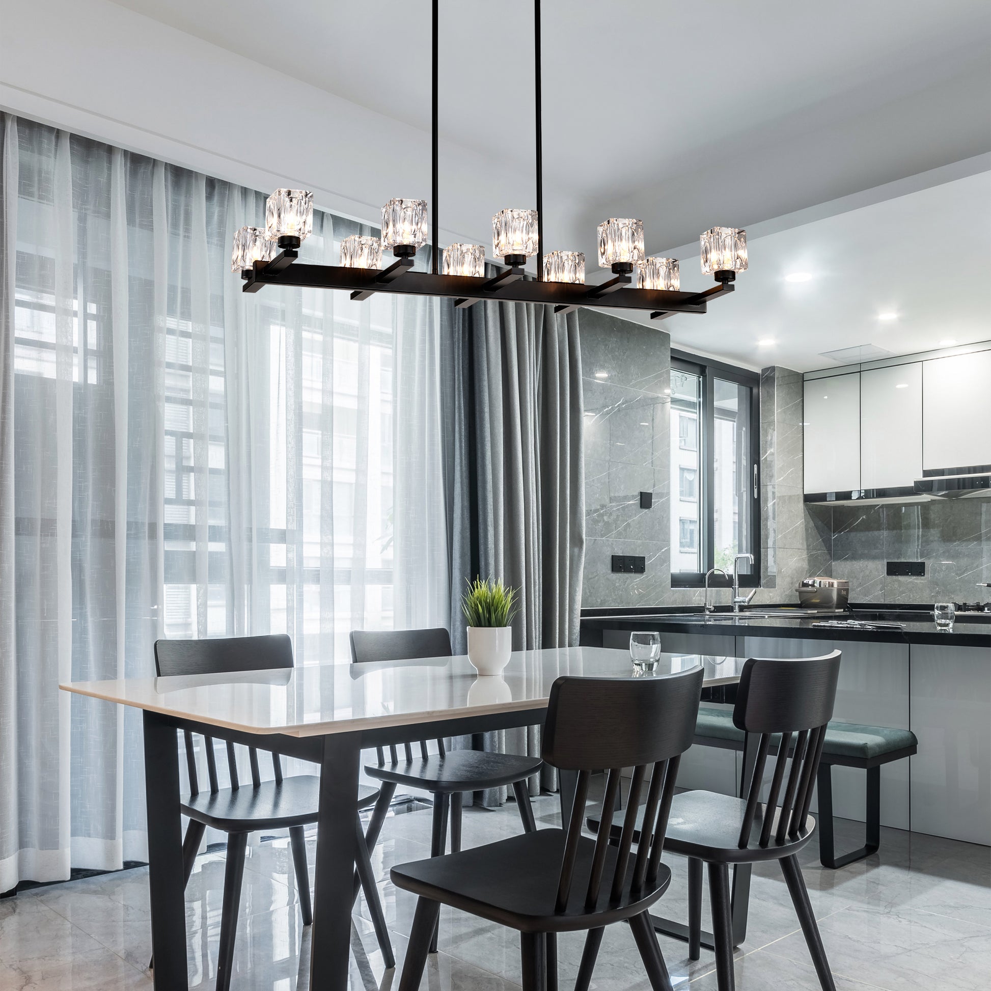 Modern black chandelier with crystal accents illuminating a dining area