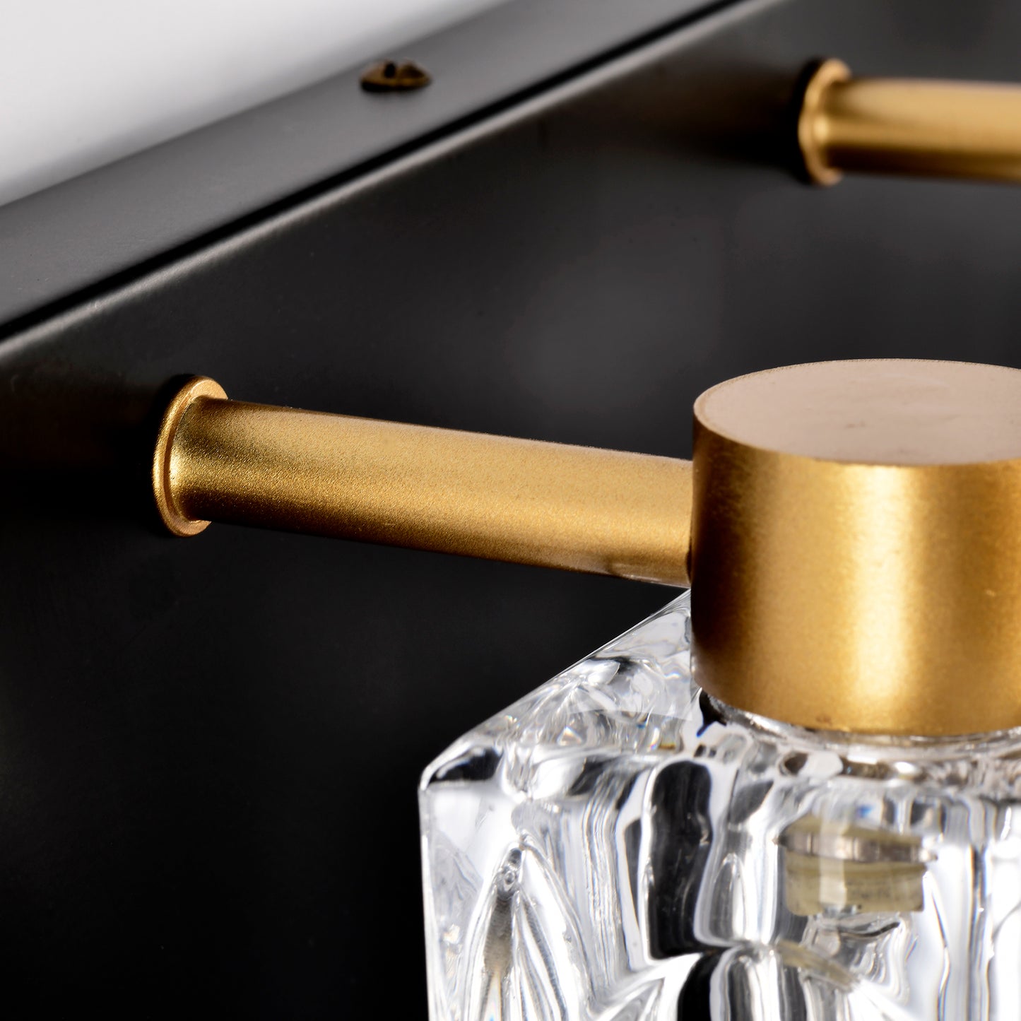Closeup of a brass handle with a crystal accent on a matte black base modern design