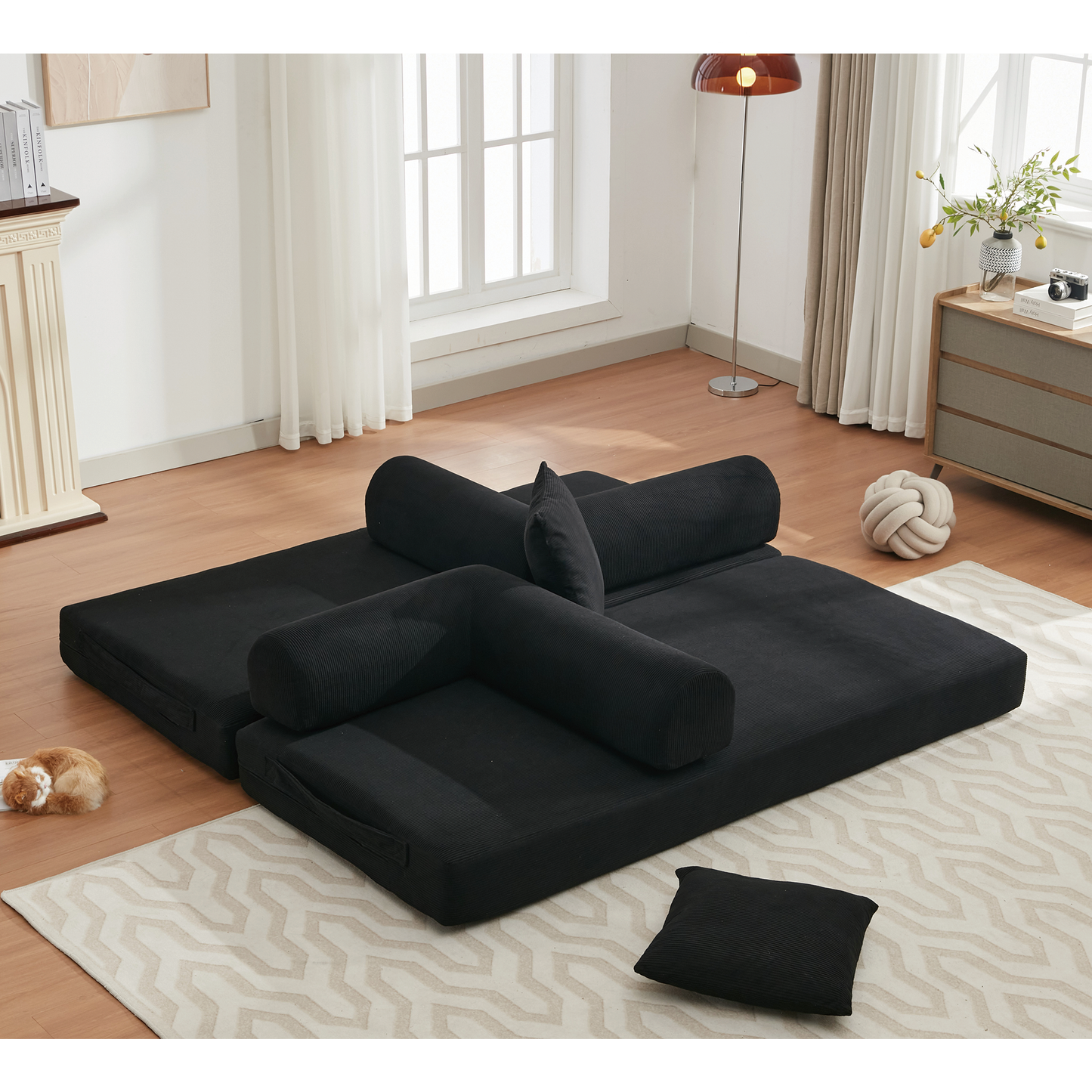Black corduroy sectional sofa with bolsters for versatile living room use
