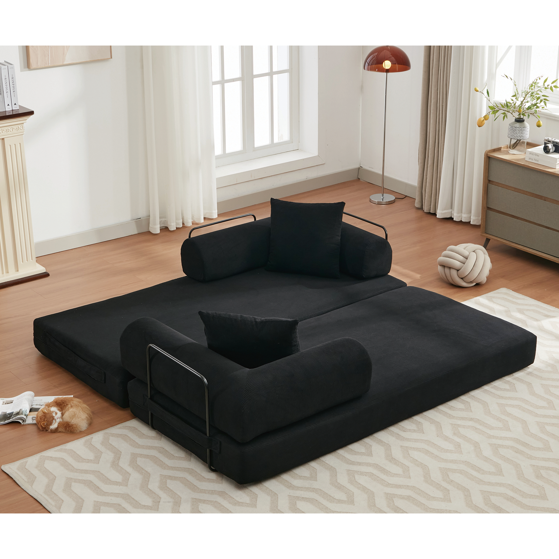 Black corduroy futon sofa with removable bolsters and accent pillows