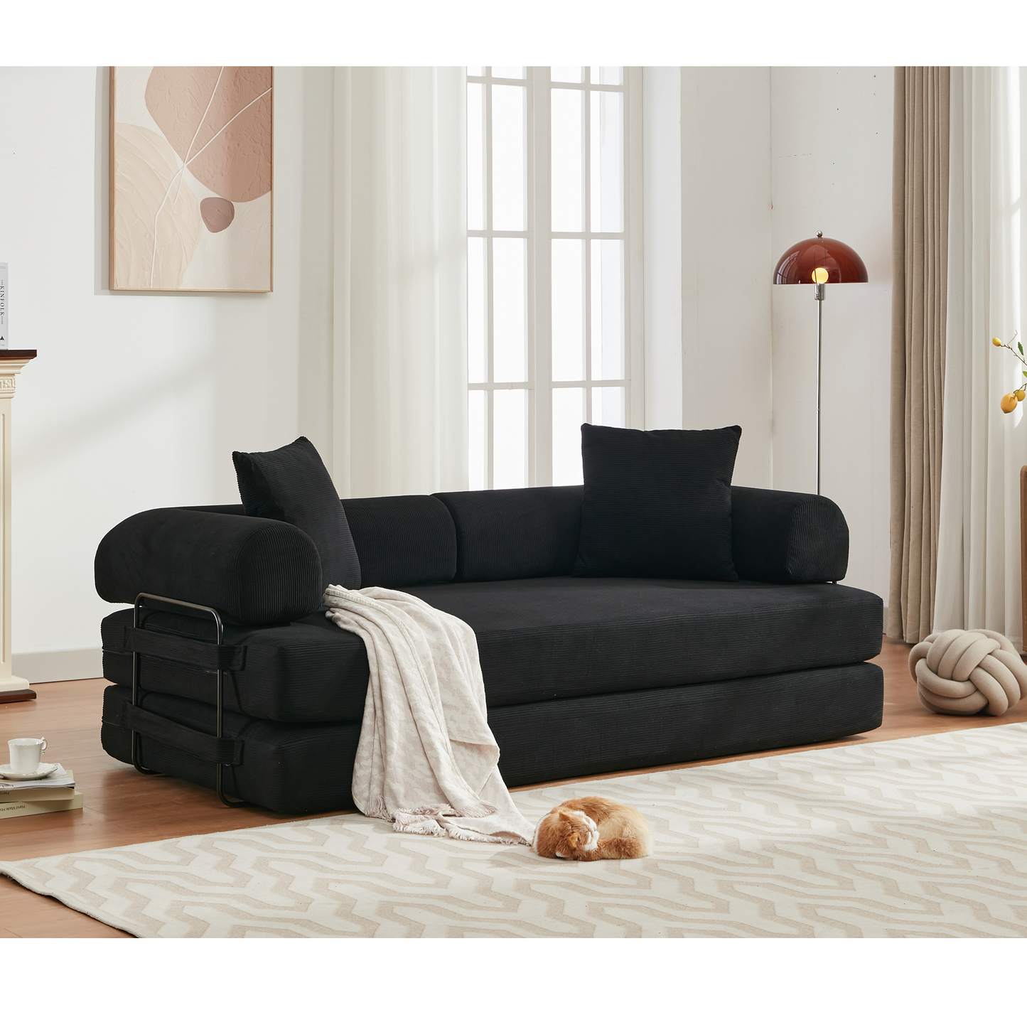 Black corduroy sofa bed with plush throw blanket for living room comfort