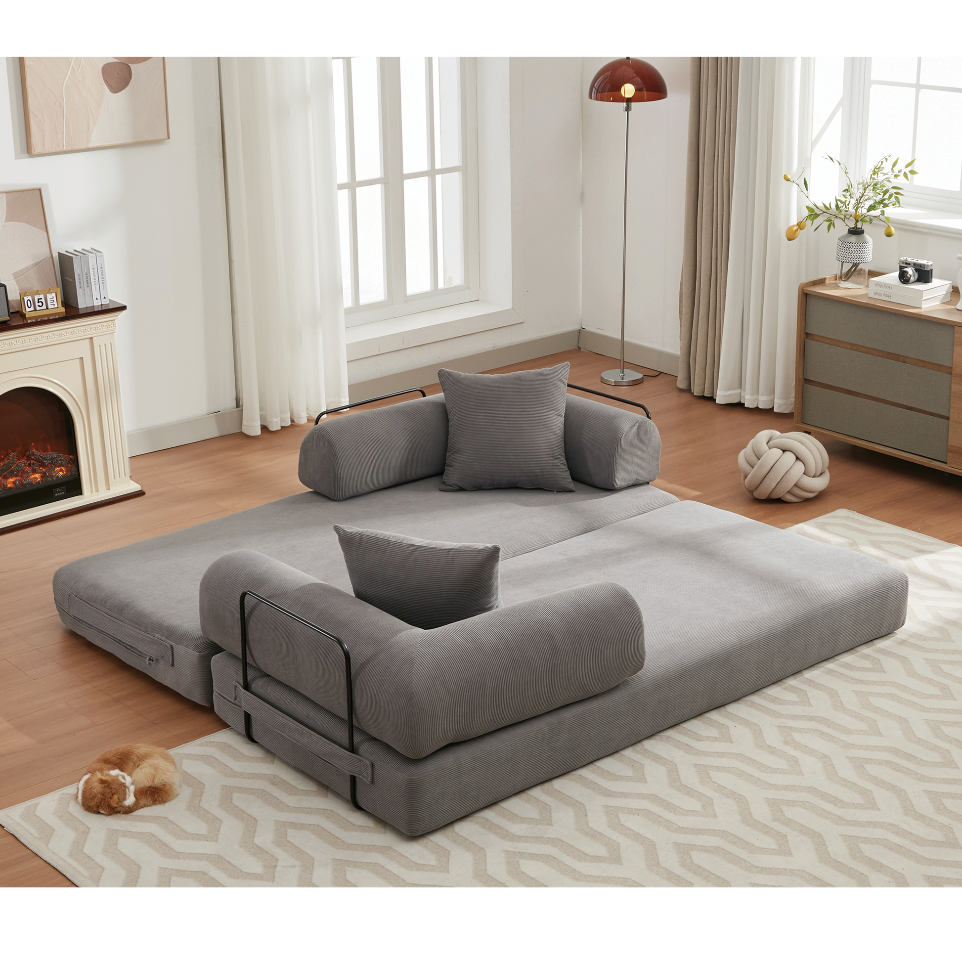 Gray corduroy futon sofa bed with supportive armrests and pillows ideal for small spaces