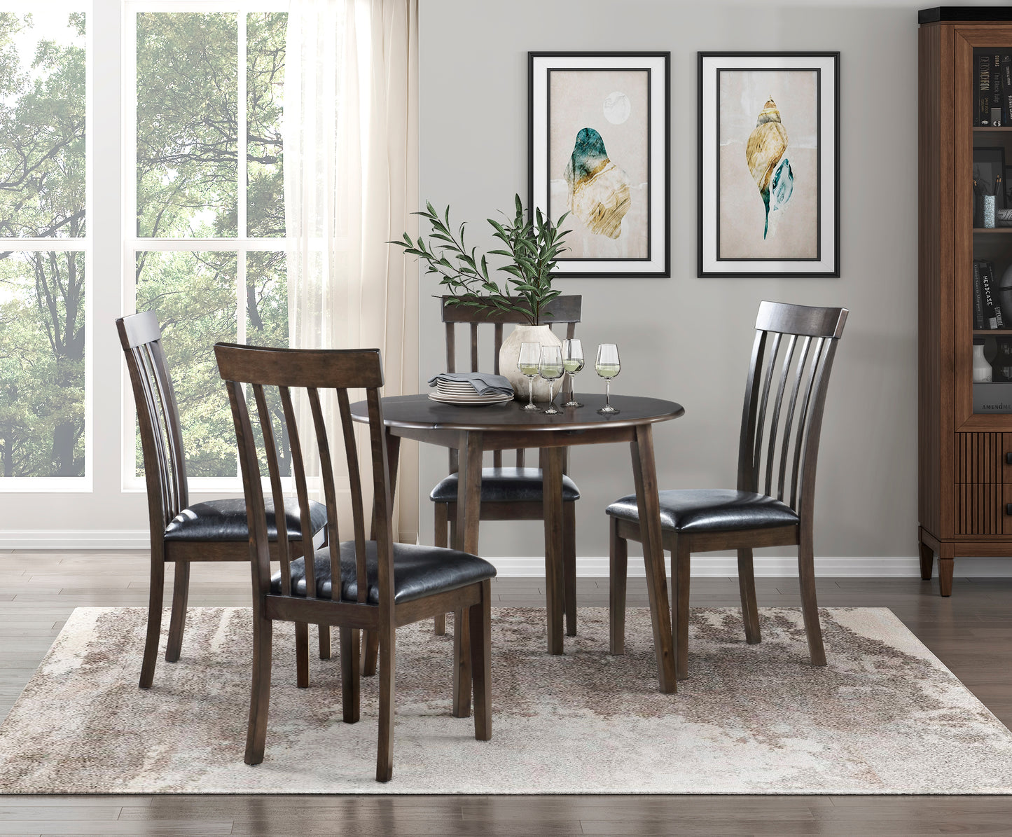 Round dark wood dining table with four slatted back chairs with black leather seats