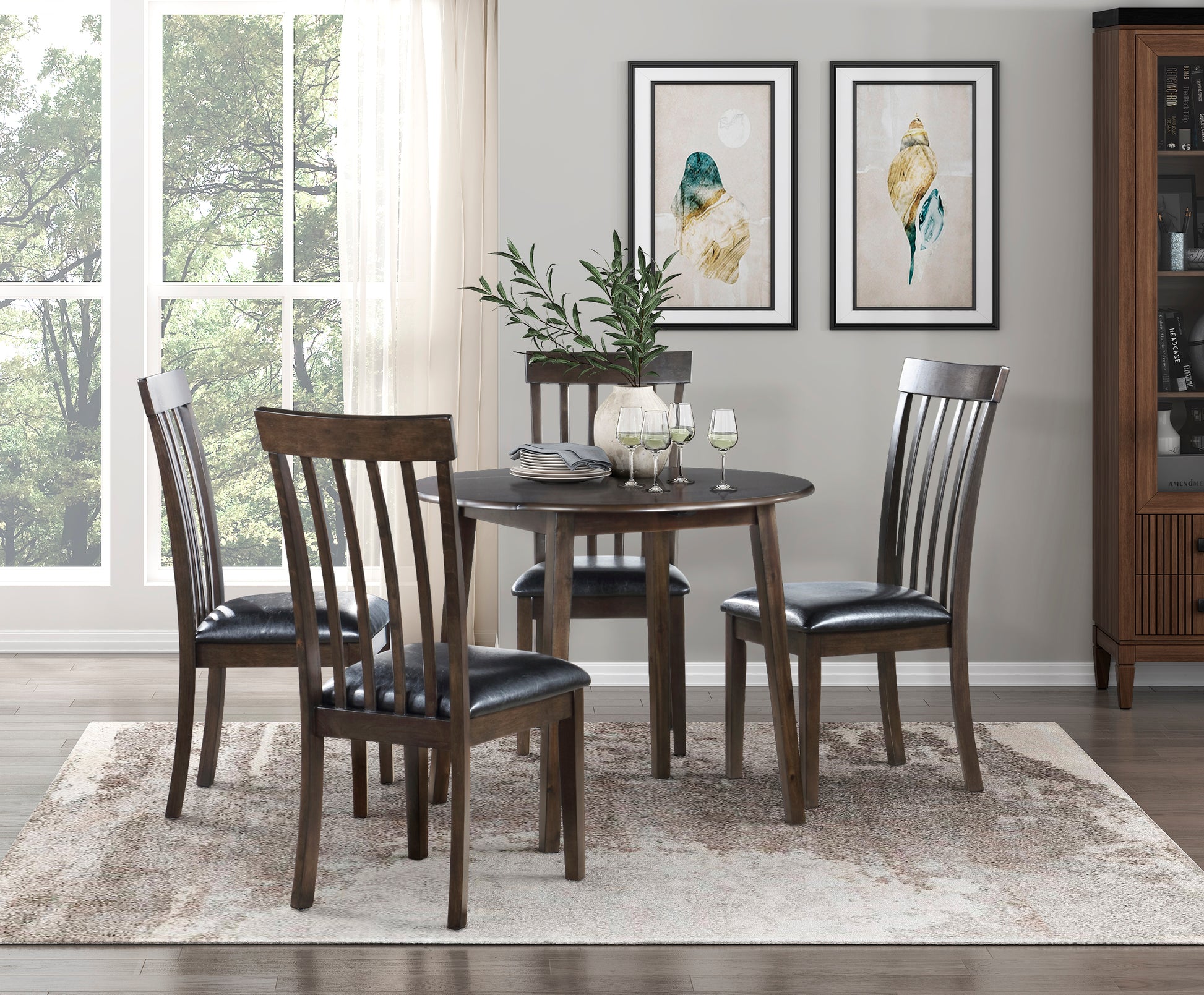 Round dark wood dining table with four slatted back chairs with black leather seats