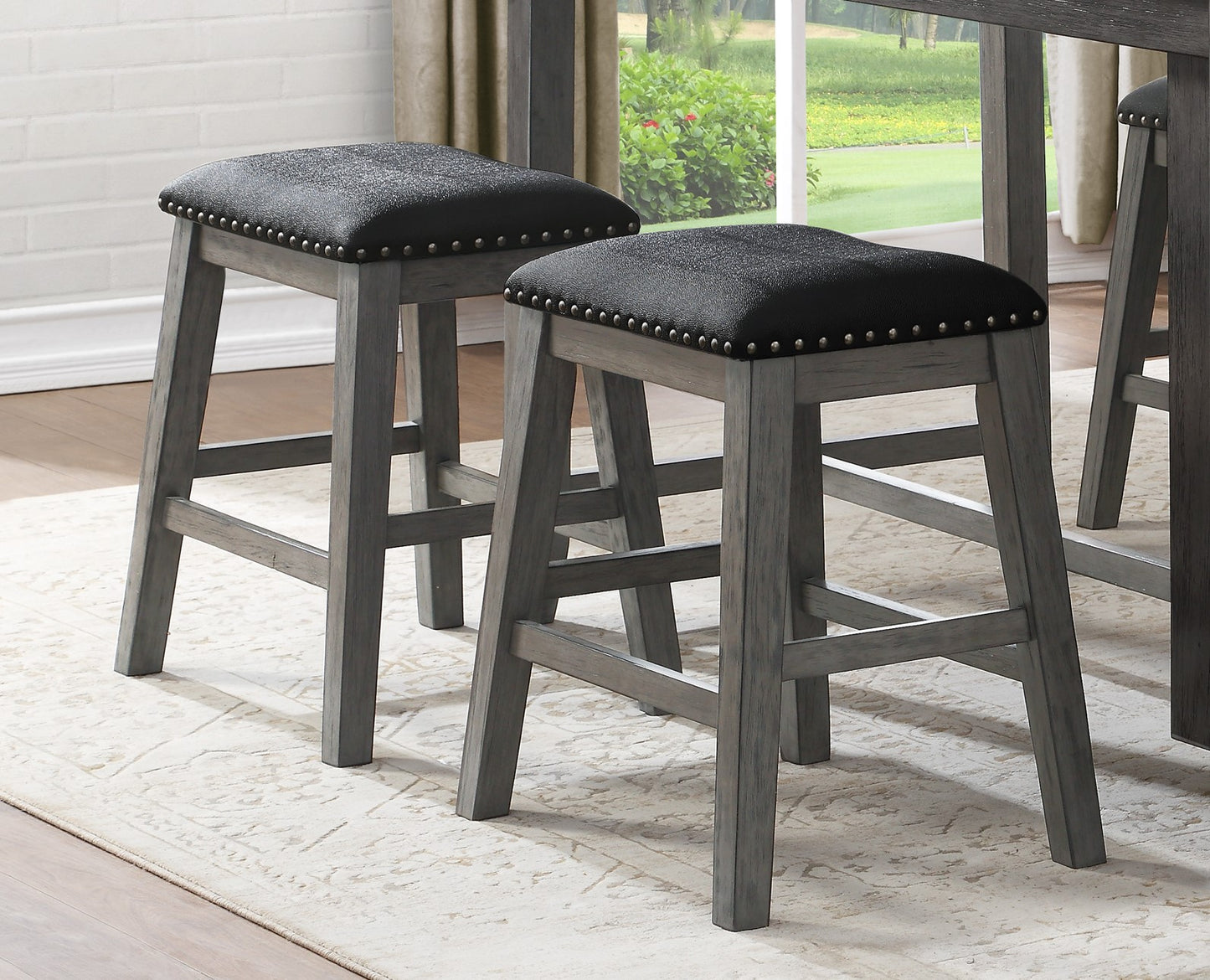 Grey wooden counter height stool with black studded upholstered seat