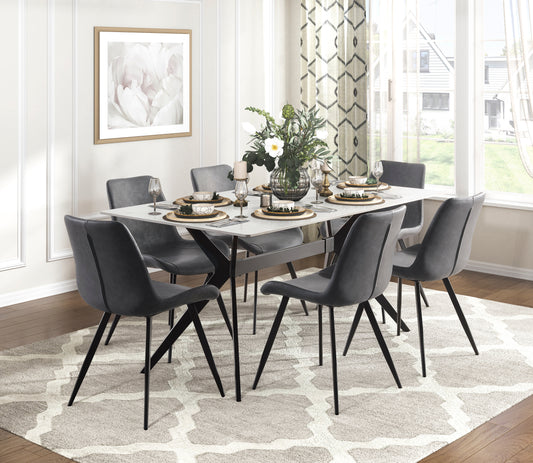 Modern grey leather dining chairs with black metal legs surround a white dining table