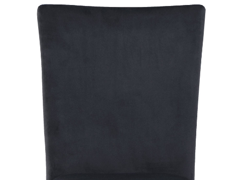Closeup of a dark gray velvet chair back with a slightly curved design ideal for modern dining rooms
