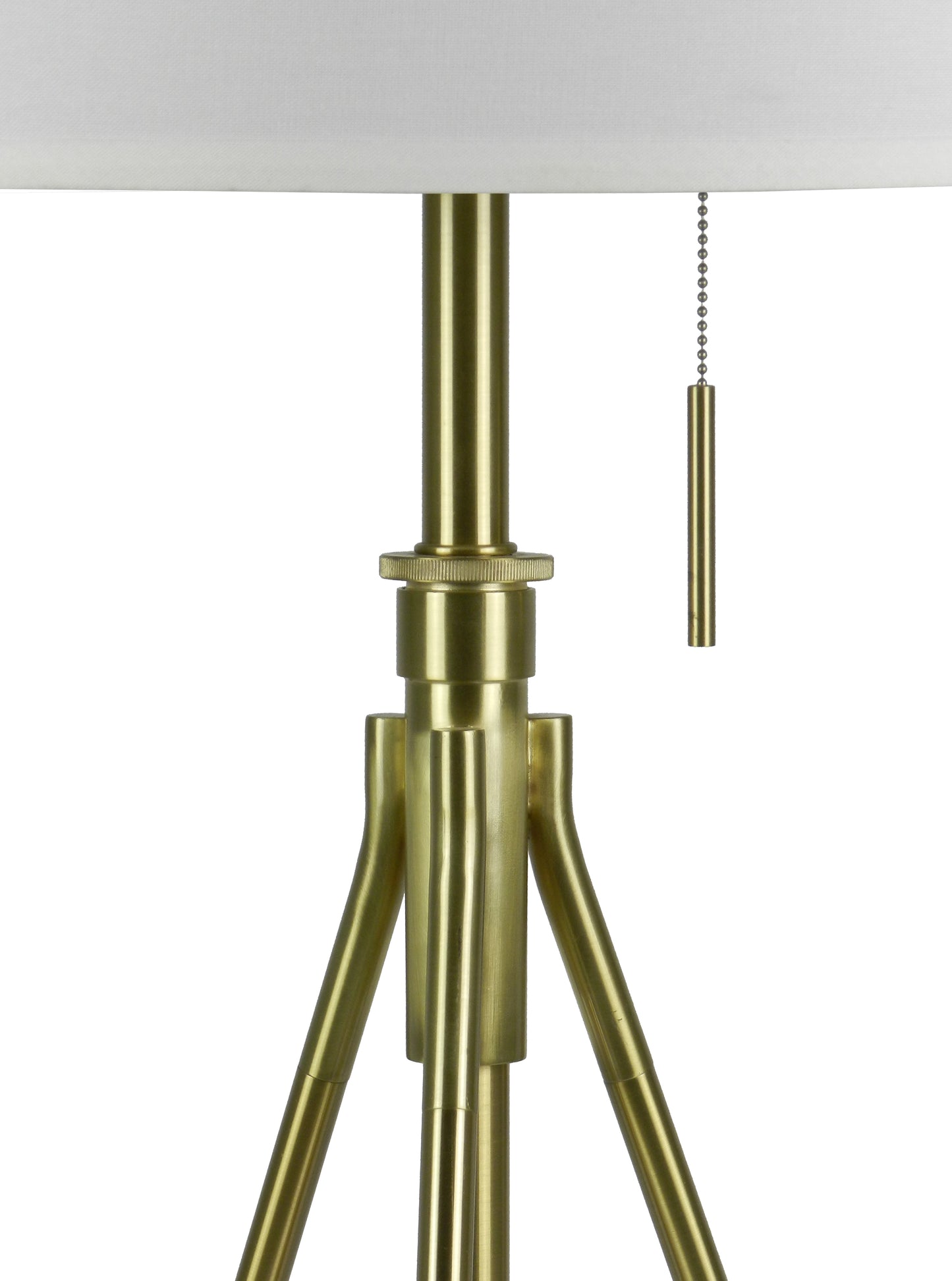 Close up of a brushed brass floor lamp base with tripod legs and a white shade