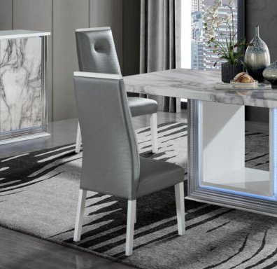 Contemporary grey faux leather dining chair with white legs and tufted back