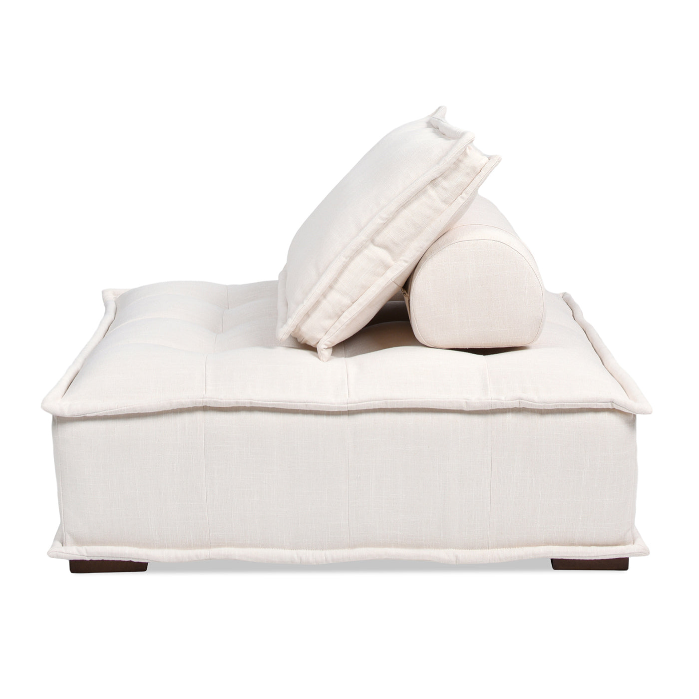 Cream upholstered modular sofa with tufted seat and accent pillows
