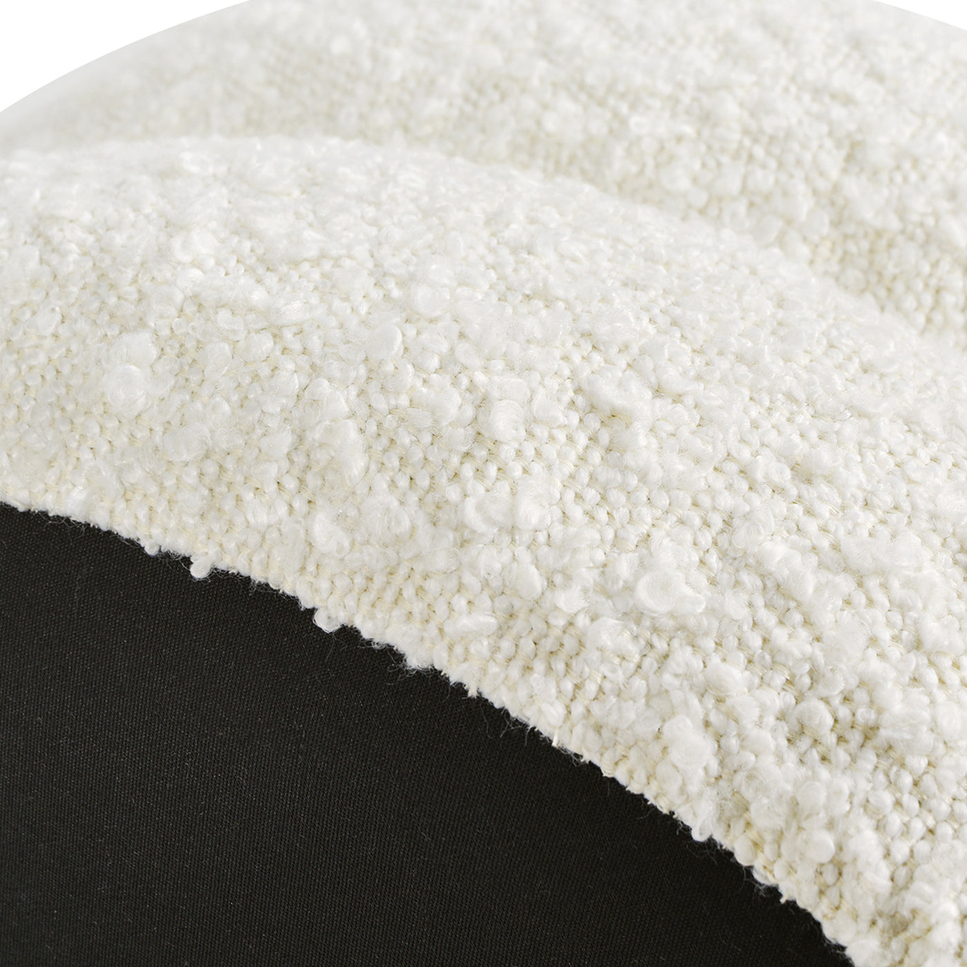 Closeup of plush ivory boucle fabric with a textured nubby surface