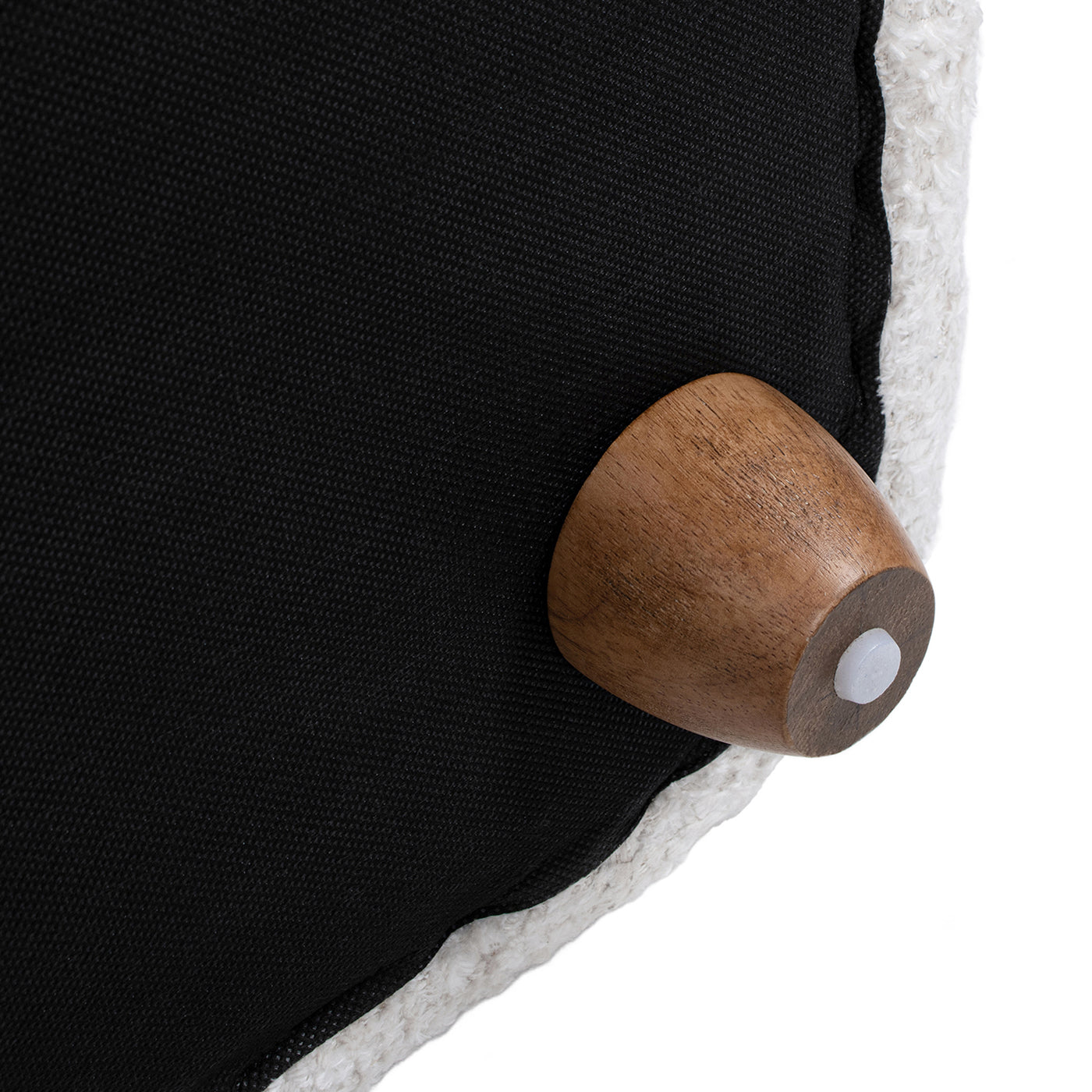 Black textured fabric with a natural wood conical leg and white foot pad part of an ottoman