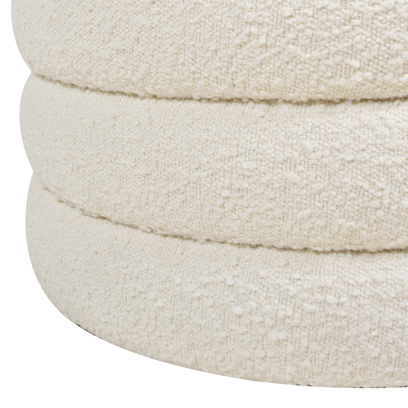 Textured cream boucle ottoman with curved stacked design providing comfortable seating
