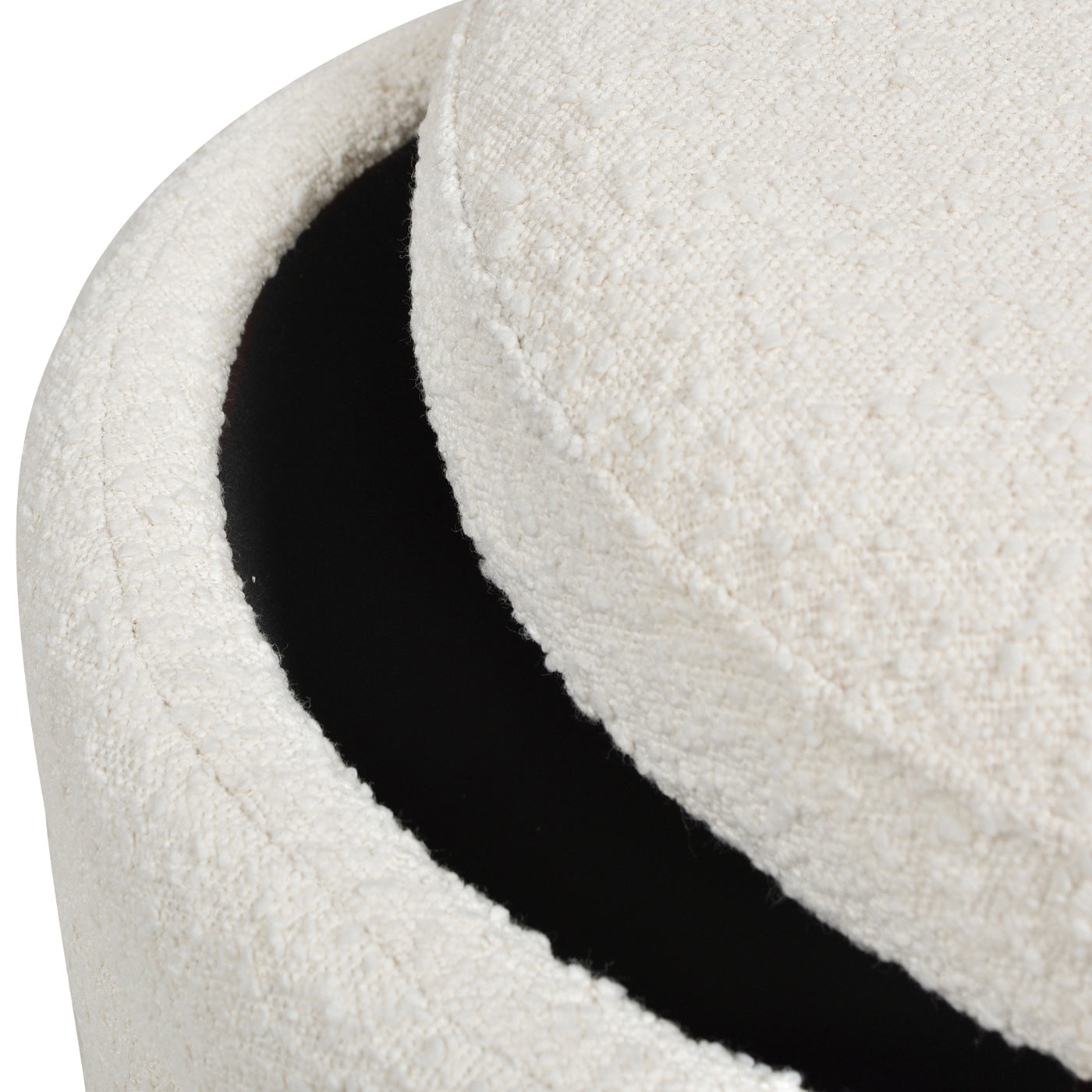 Textured cream fabric ottoman with dark interior providing stylish storage