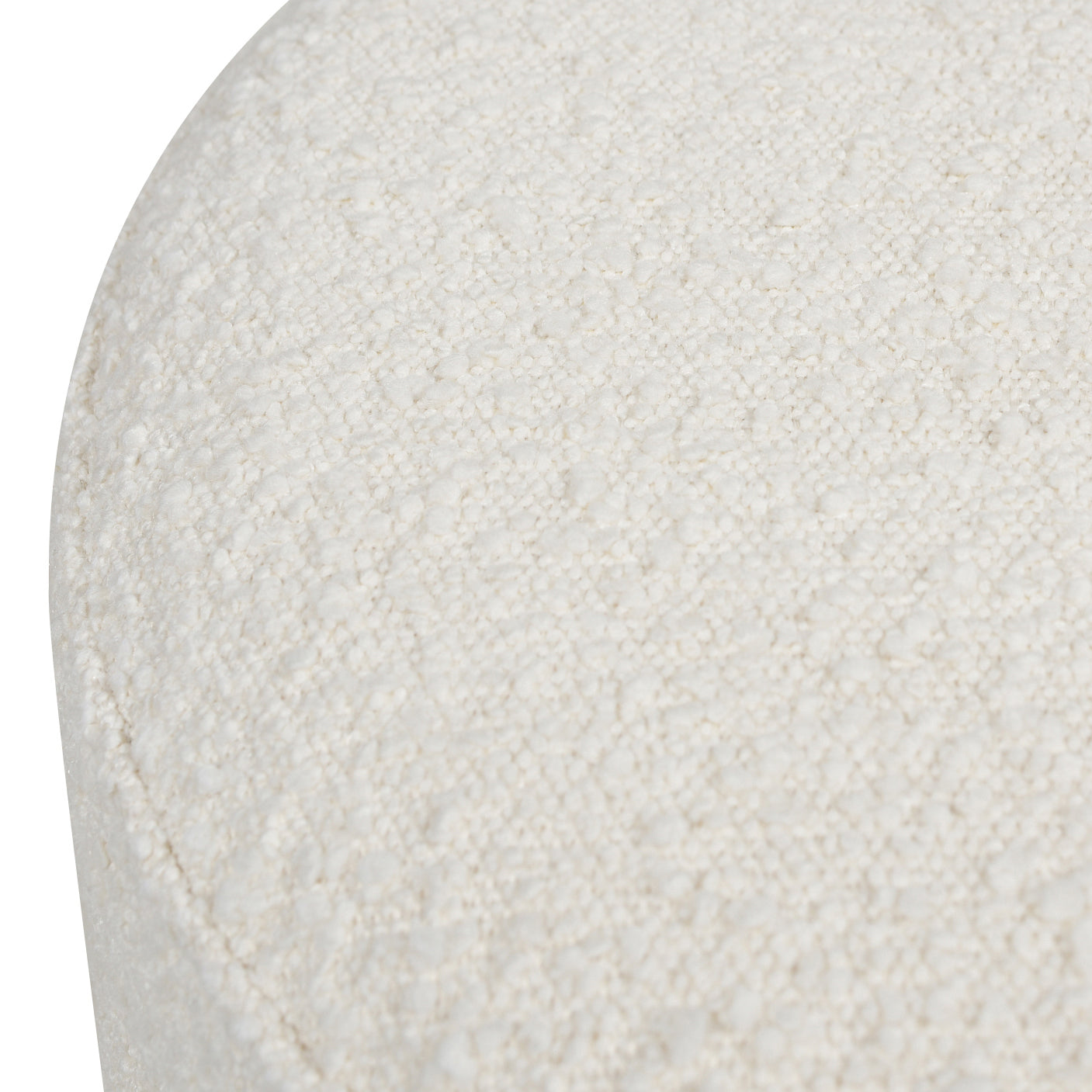 Textured offwhite boucle fabric on a rounded ottoman surface