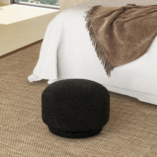 Textured black boucl ottoman for a cozy bedroom accent