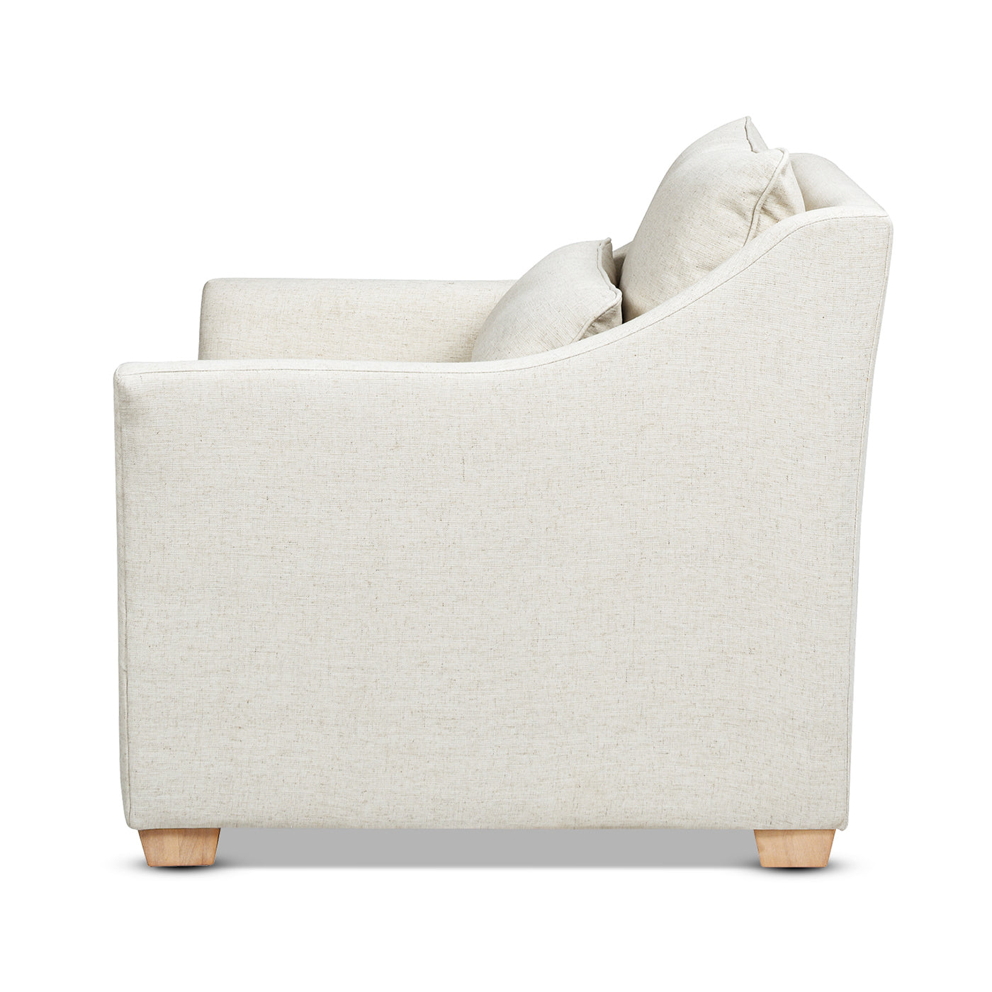 Side view of a cream linen armchair with plush cushions and wooden block feet