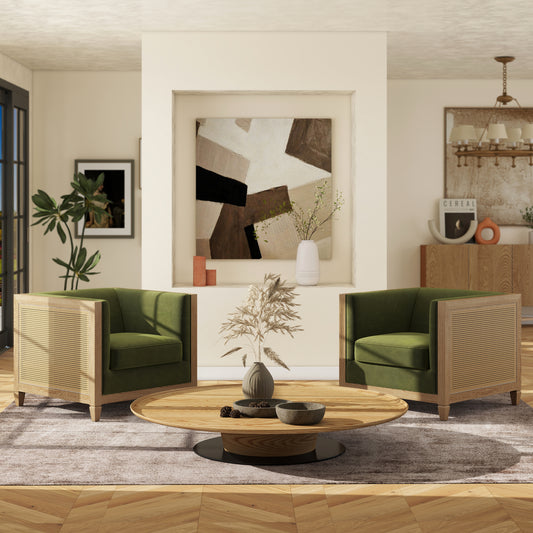 Emerald green velvet armchair with woven cane sides and light wood frame