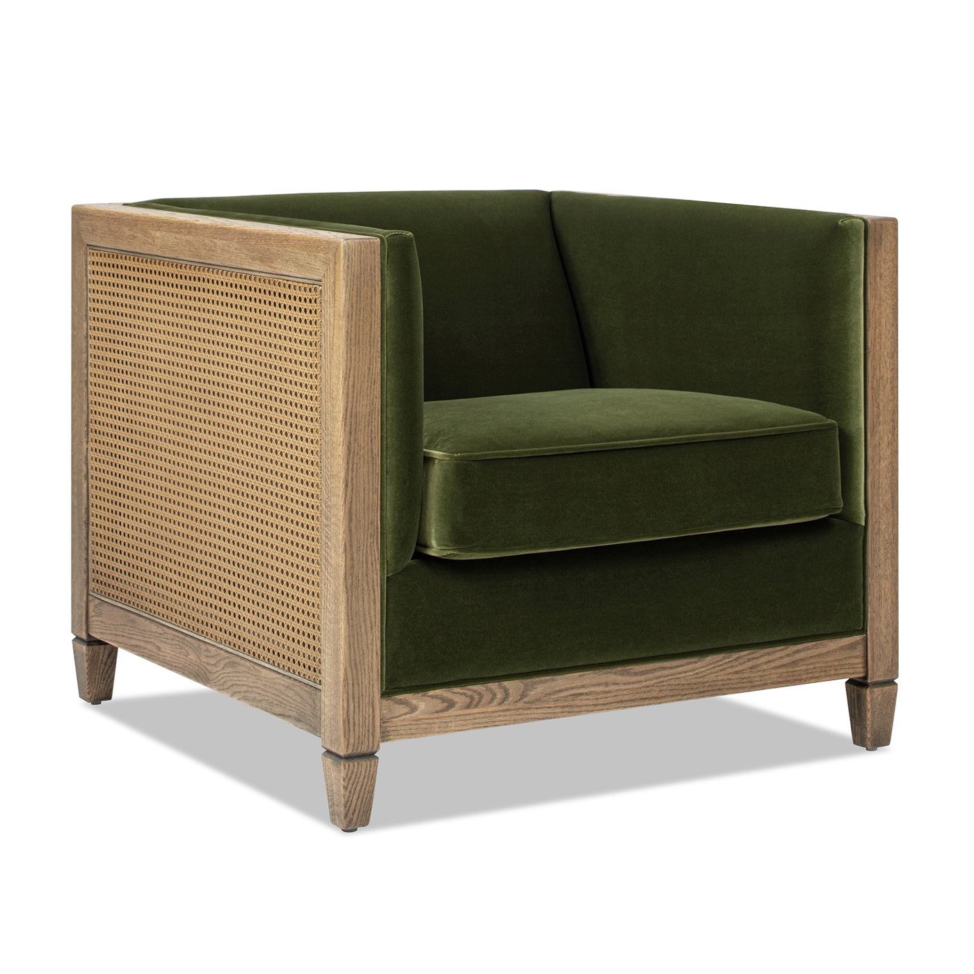 Green velvet armchair with natural wood frame and cane detailing