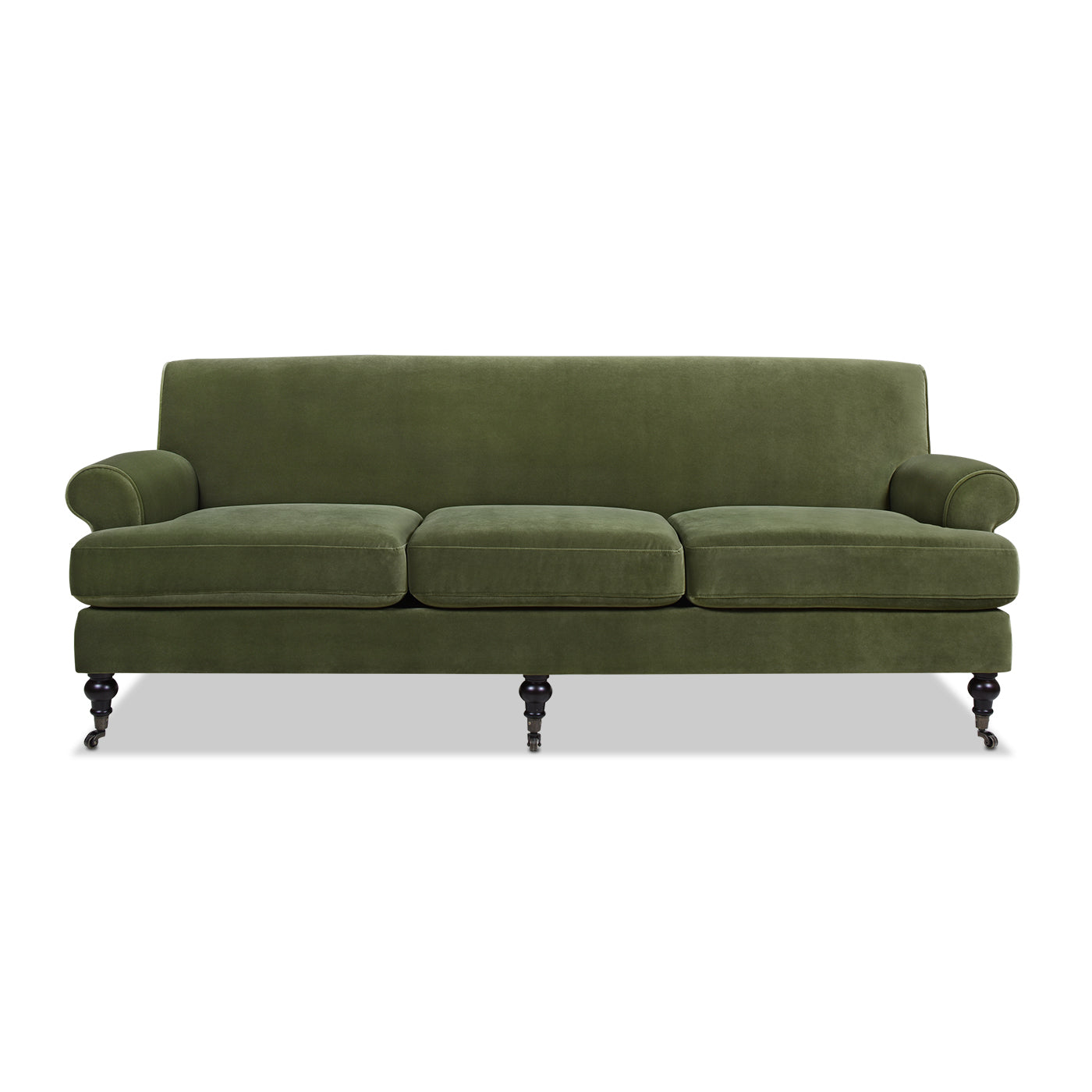 Classic green velvet threeseater sofa with rolled arms and dark wooden legs on casters
