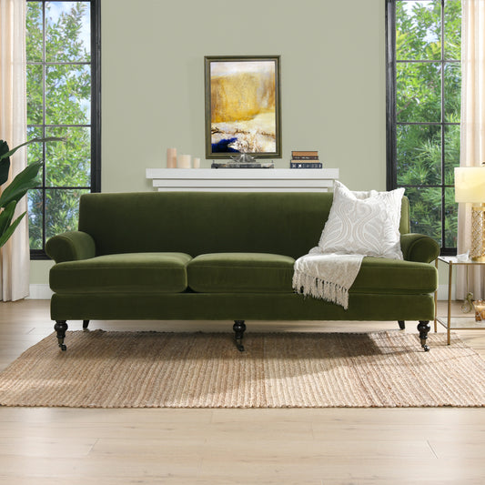 Deep green velvet sofa with plush cushions and caster wheels modern living room accent