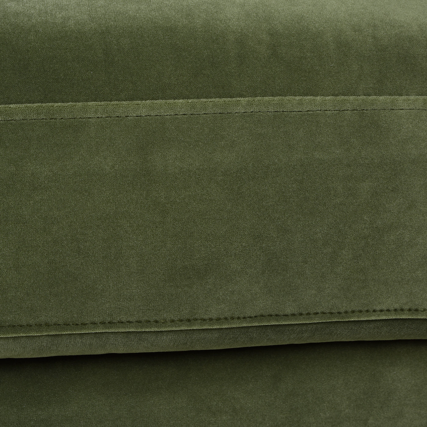 Closeup of olive green velvet fabric texture with subtle stitching detail