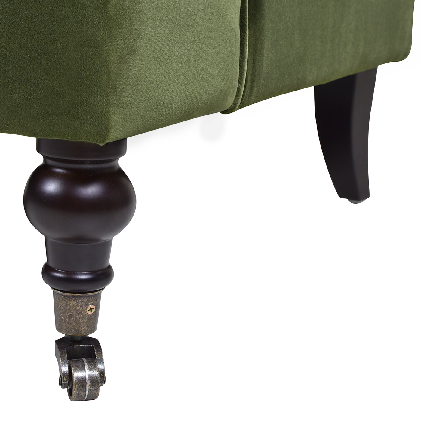 Dark wood bun foot with antique brass caster on green velvet sofa leg