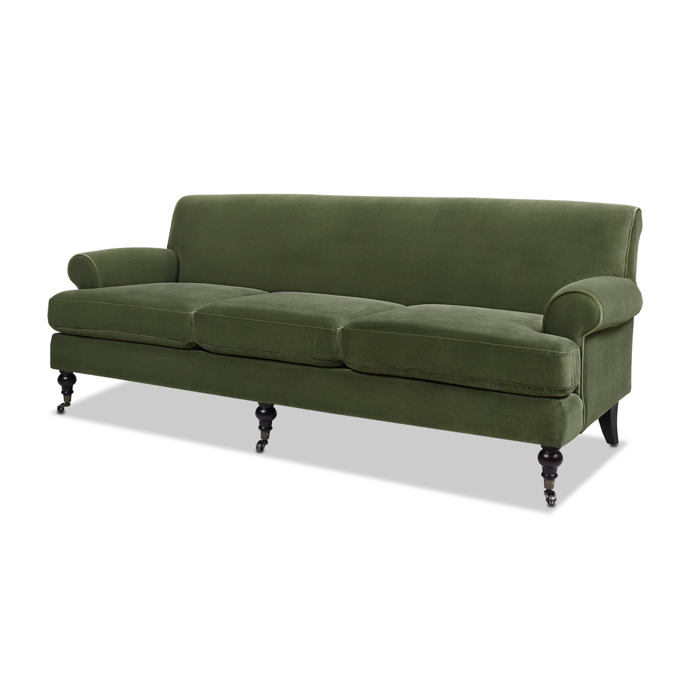 Deep green velvet sofa with rolled arms and classic bun feet with casters