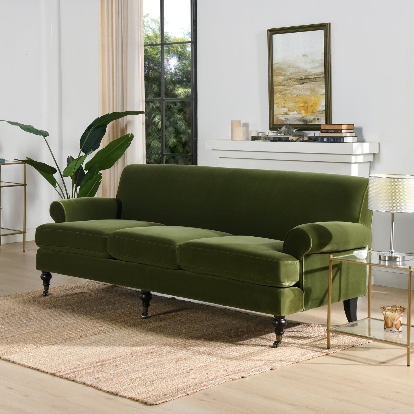 Plush green velvet sofa with ornate legs on a jute rug