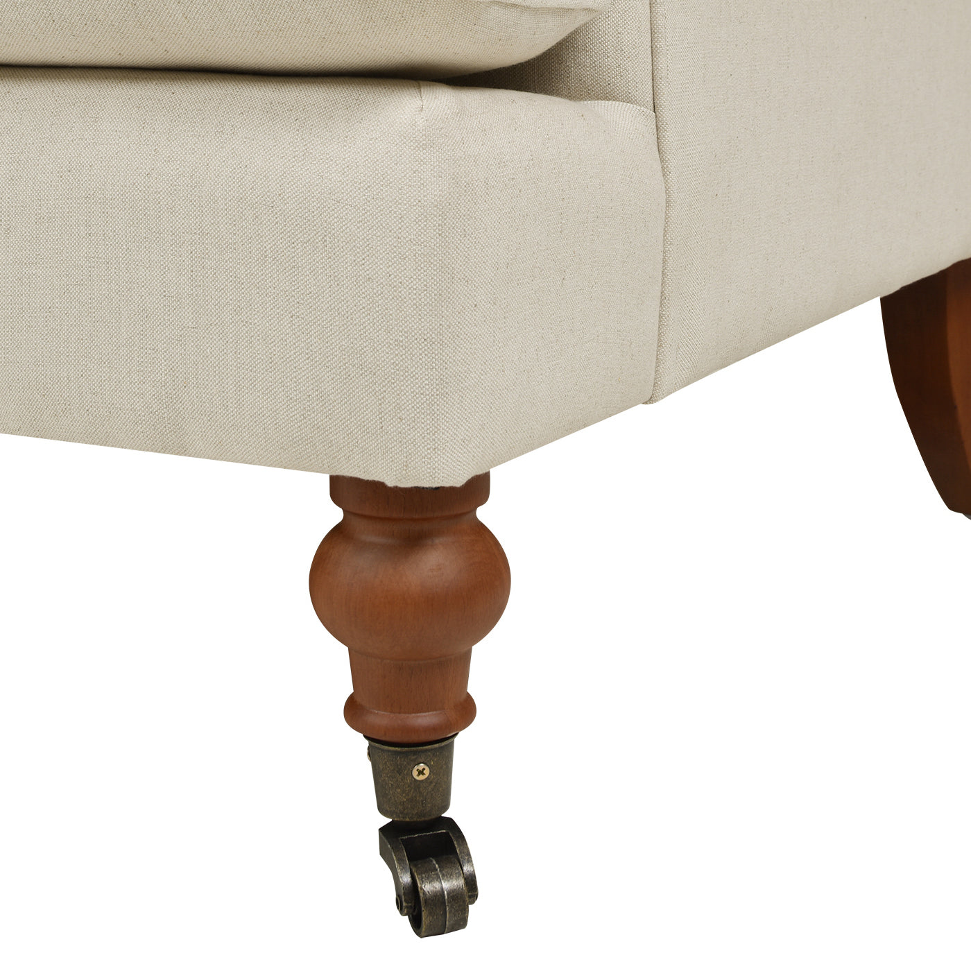 Cream linen upholstered sofa leg with ornate wood and brass caster